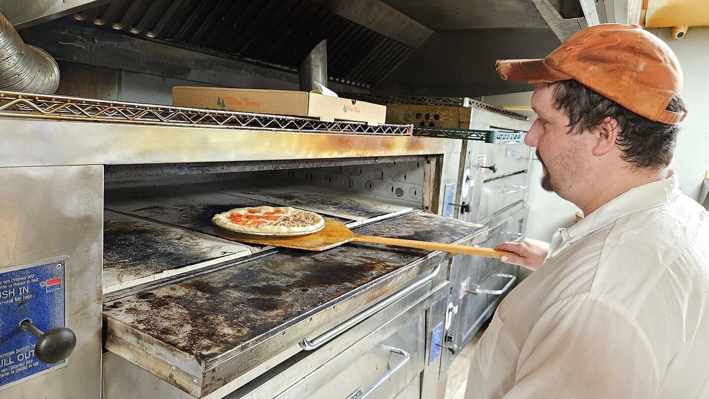 A pizza going into the Twin Trees oven
